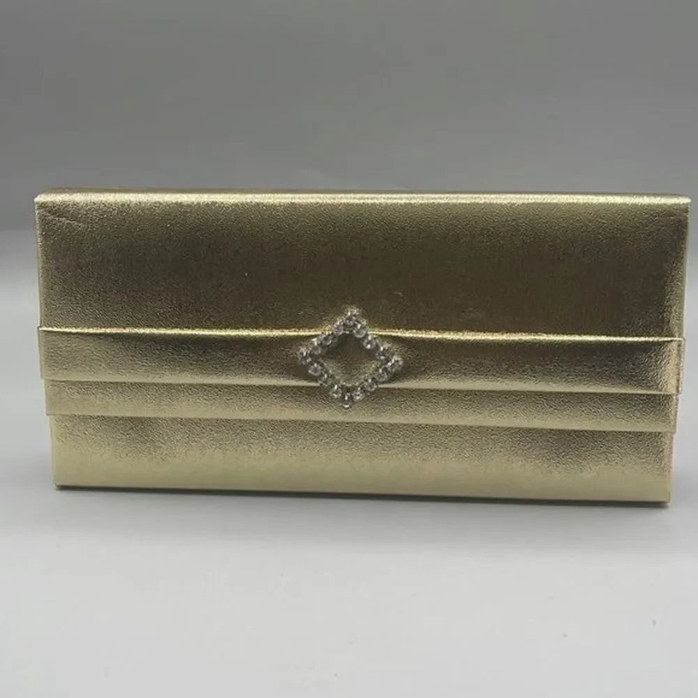 Vintage faux leather gold clutch the rhinestone closure.